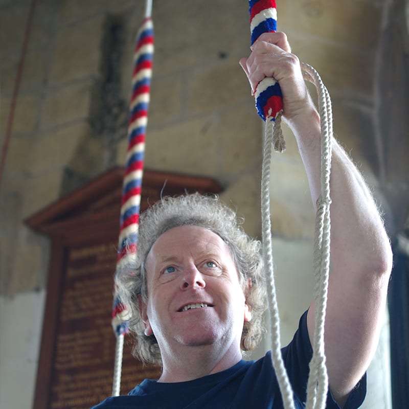 A Minster bell-ringer pulling on the sally in the ringing chamber.