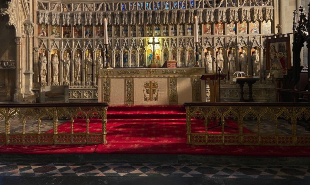 The gilded reredos at the East end, with the red carpet leading up the Sanctuary steps.