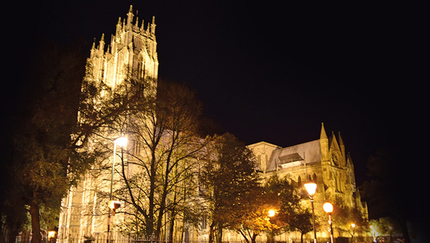 Beverley Minster floodlit at night, its twin towers against a dark sky.