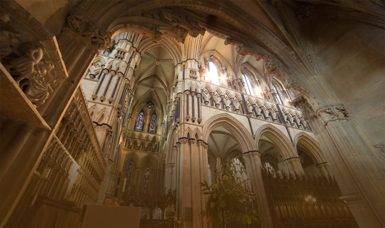 Sunlit Gothic arches inside Beverley Minster, looking up through the crossing.
