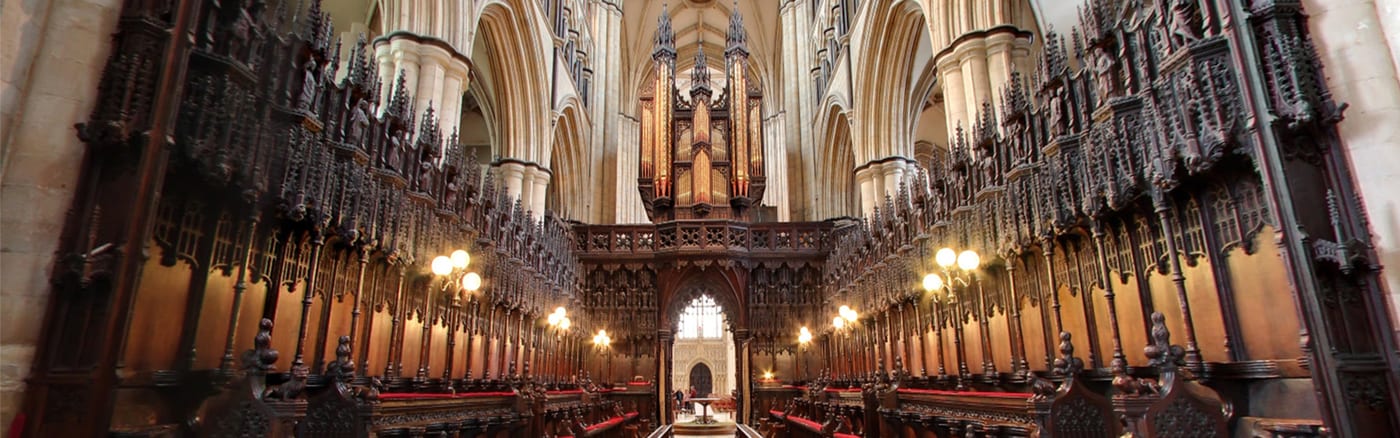 The Minster Quire — carved stalls either side, the organ above the screen — where Evensong is sung.
