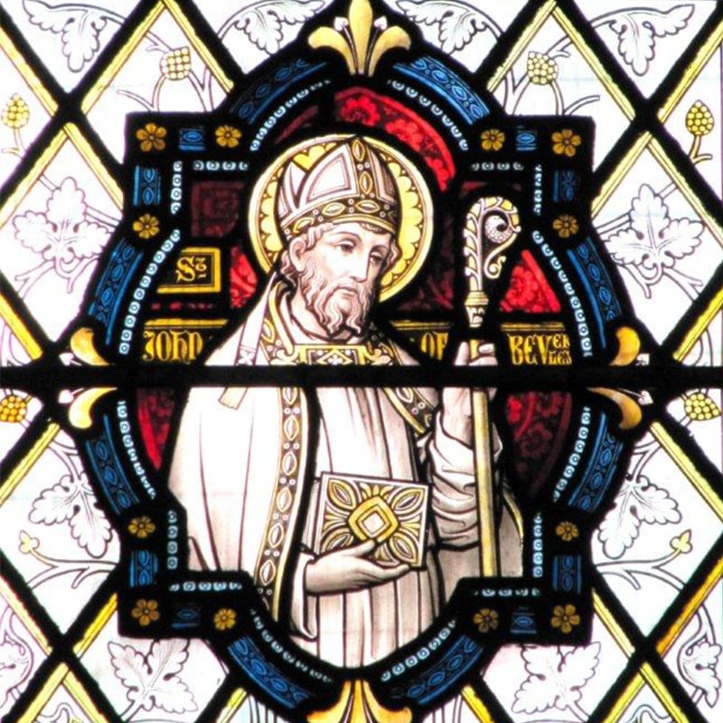 Saint John of Beverley depicted in Minster stained glass — a mitred bishop holding a crozier and book.